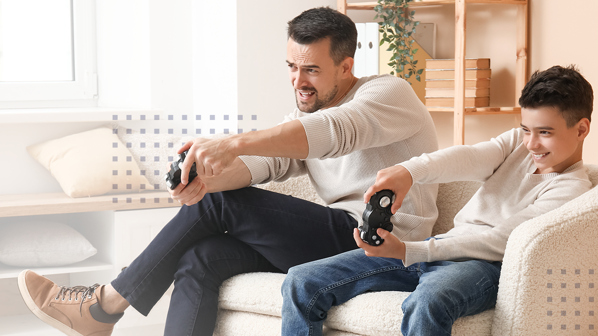 Father and son playing video games at home