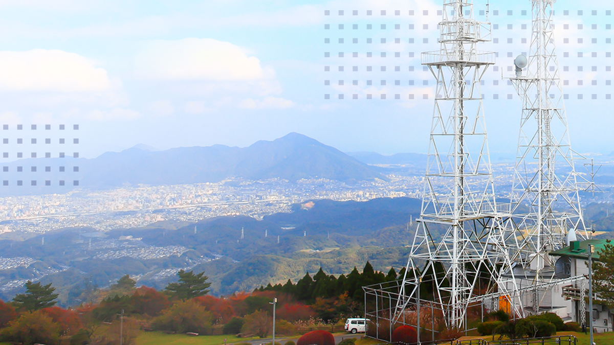 A landscape view of a cell tower for Wireless Internet Service Providers on top of a hill.