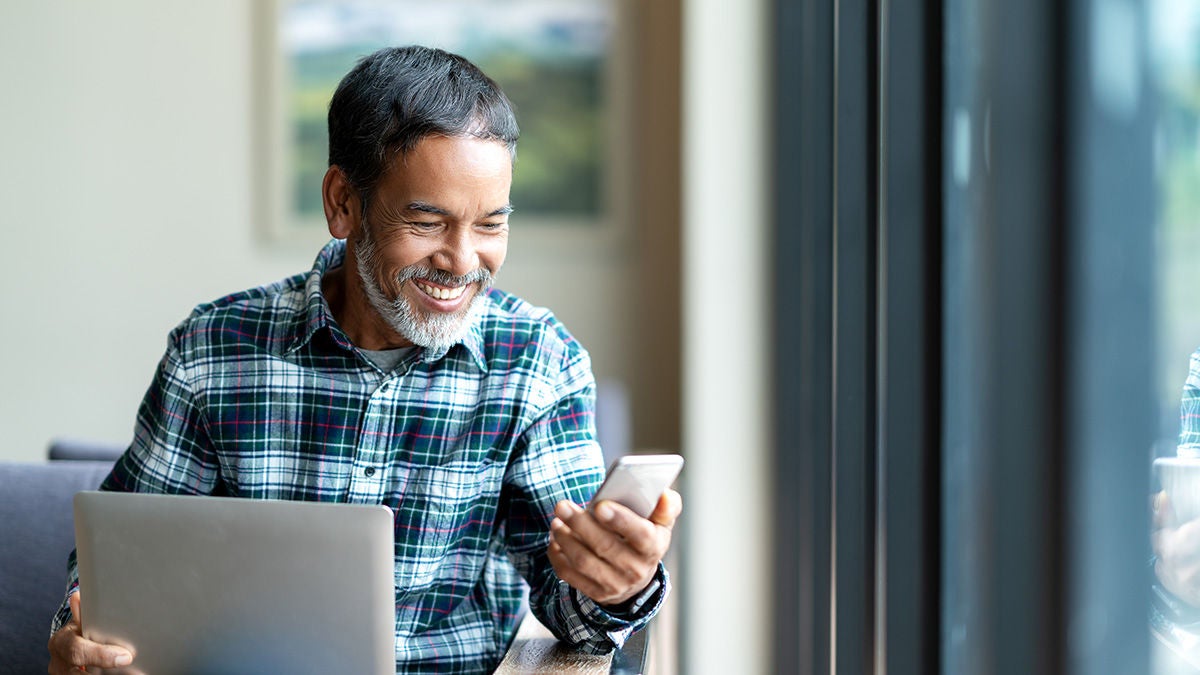 happy man looking with devices