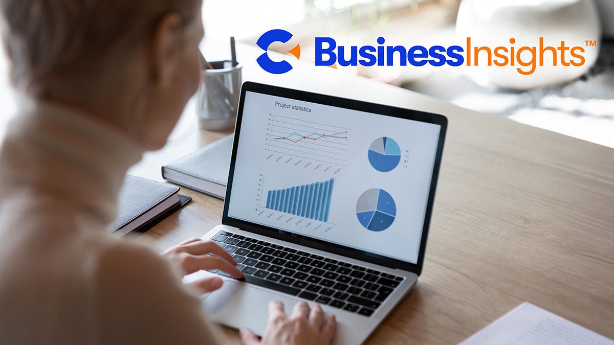 Calix Business Insights logo over woman working with charts on laptop