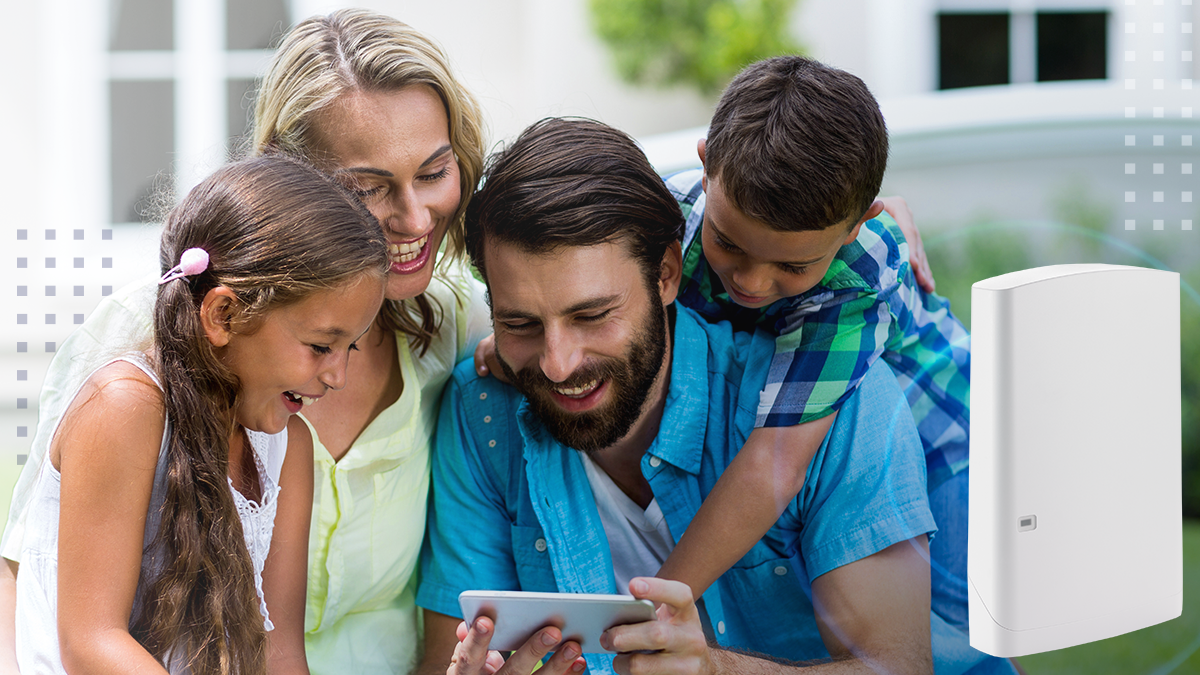 Happy family looking into mobile phone at yard 