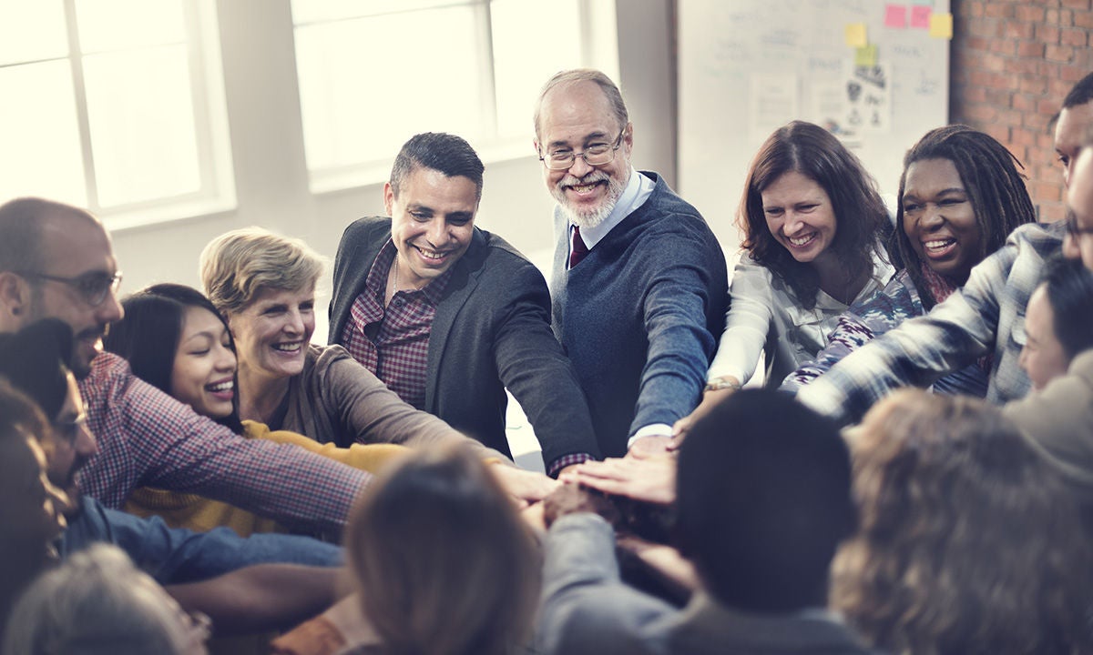 smiling team with hands together