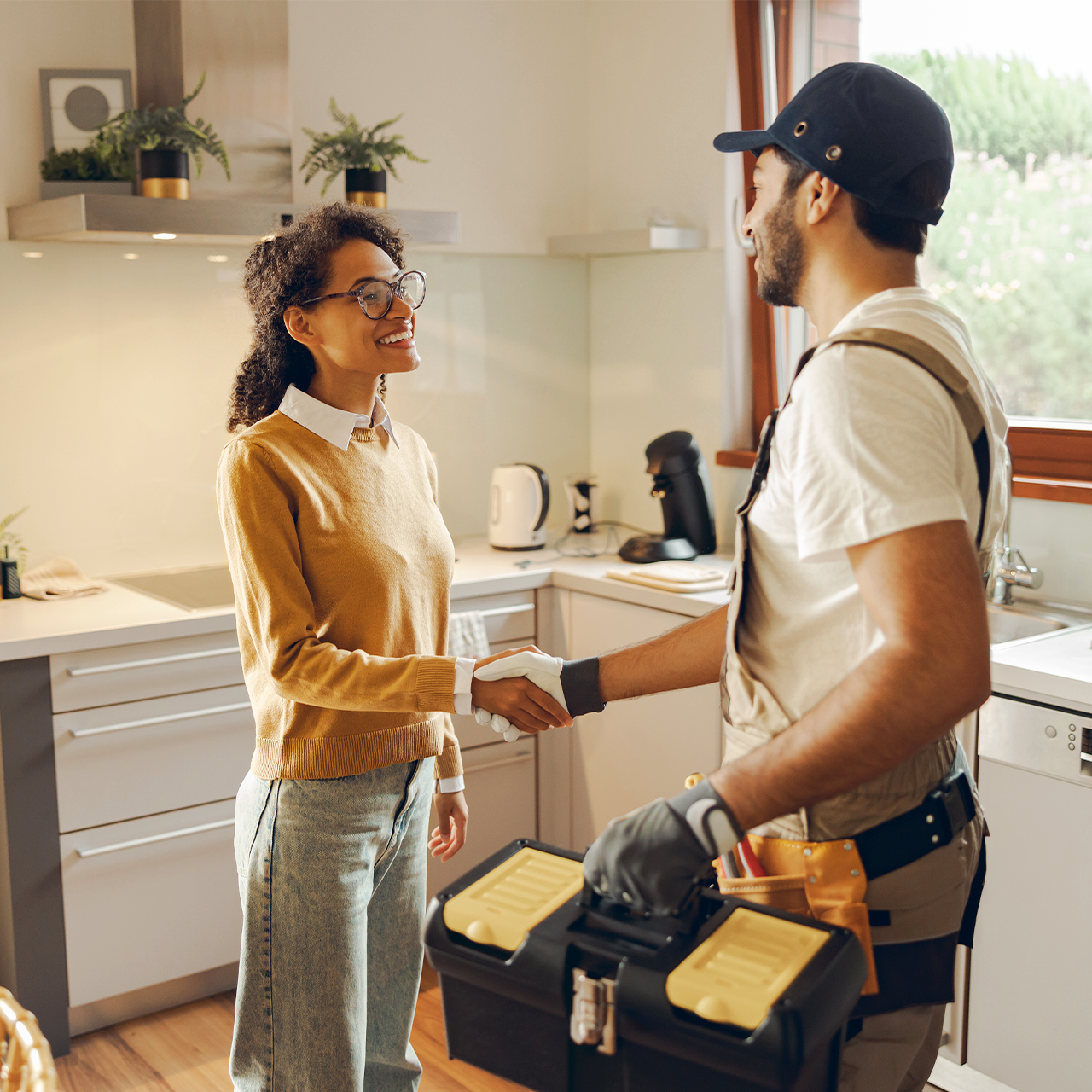 Happy technician and woman doing in-home service