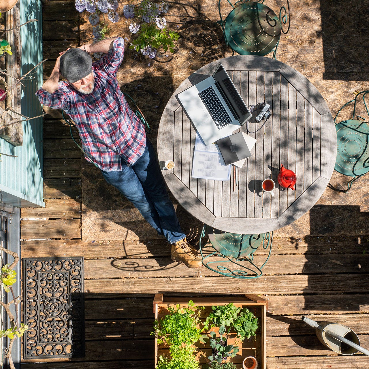 Top view of a relaxing man using outdoor wi-fi on his laptop