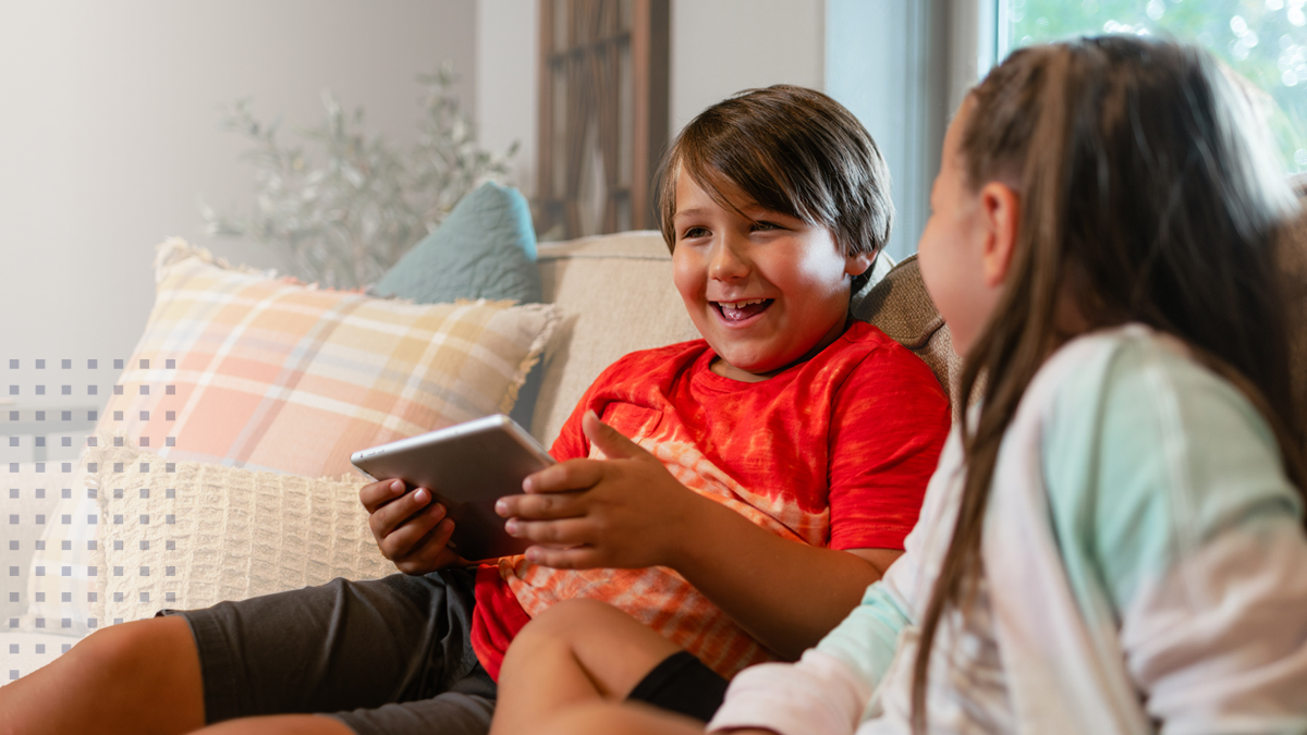 A young boy in a tribal community using broadband on a tablet