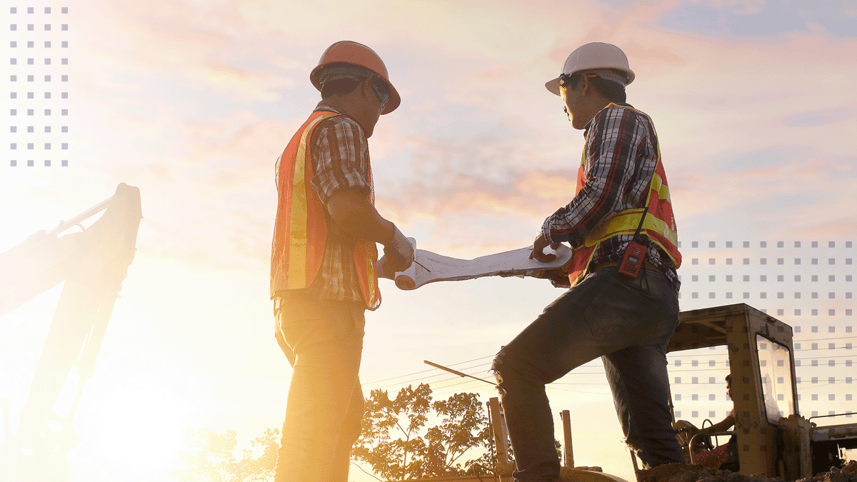 Engineer and foreman worker team with blueprints checking project at the site