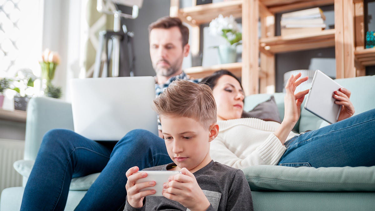 Family in living room with devices
