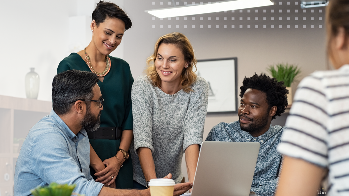 office coworkers gathered around a laptop completing a BEAD funding application