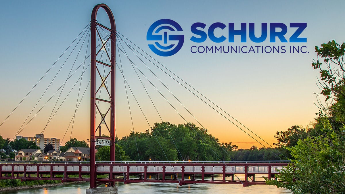 Schurz Communications logo over bridge scene