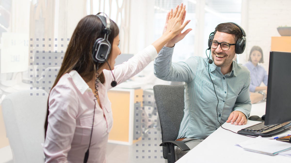 Two employees giving each other a high five