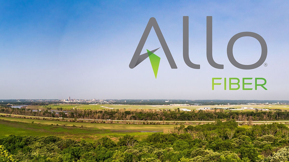 The Allo Fiber logo laid on a rural scenery with green trees