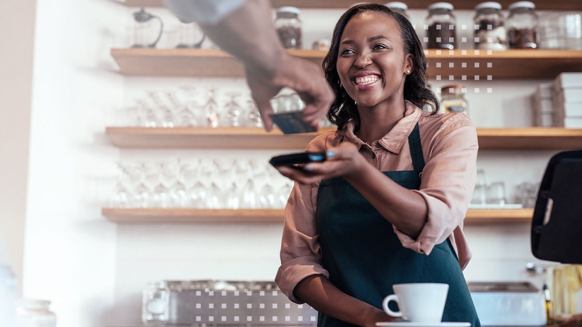 customer at coffee shop paying with touch to pay device