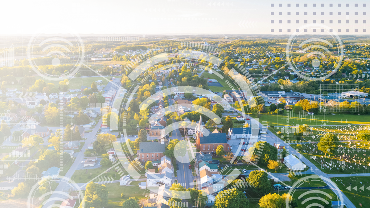 An aerial view of a small town with an overlay of community Wi-Fi icons