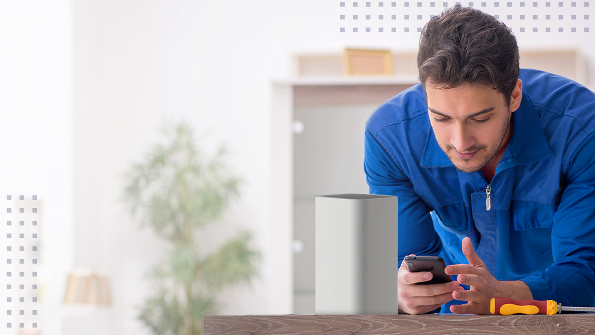 A man on his cell phone next to a wireless router using the Field Service mobile operations center app