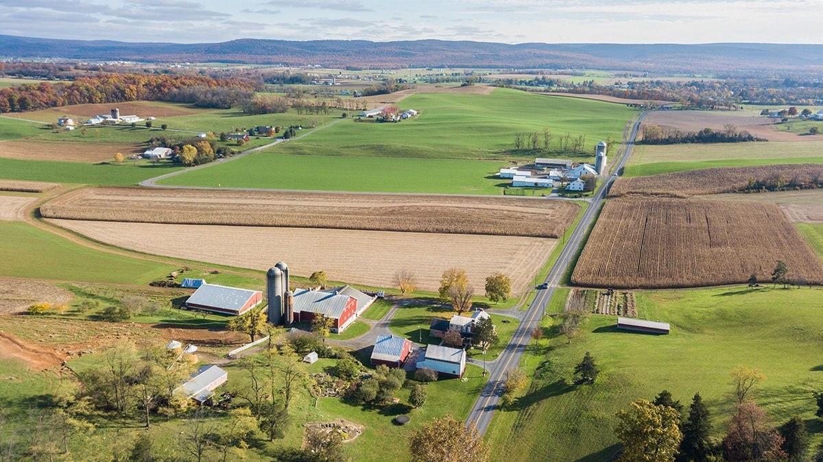 An aerial view of a rural farm with fields