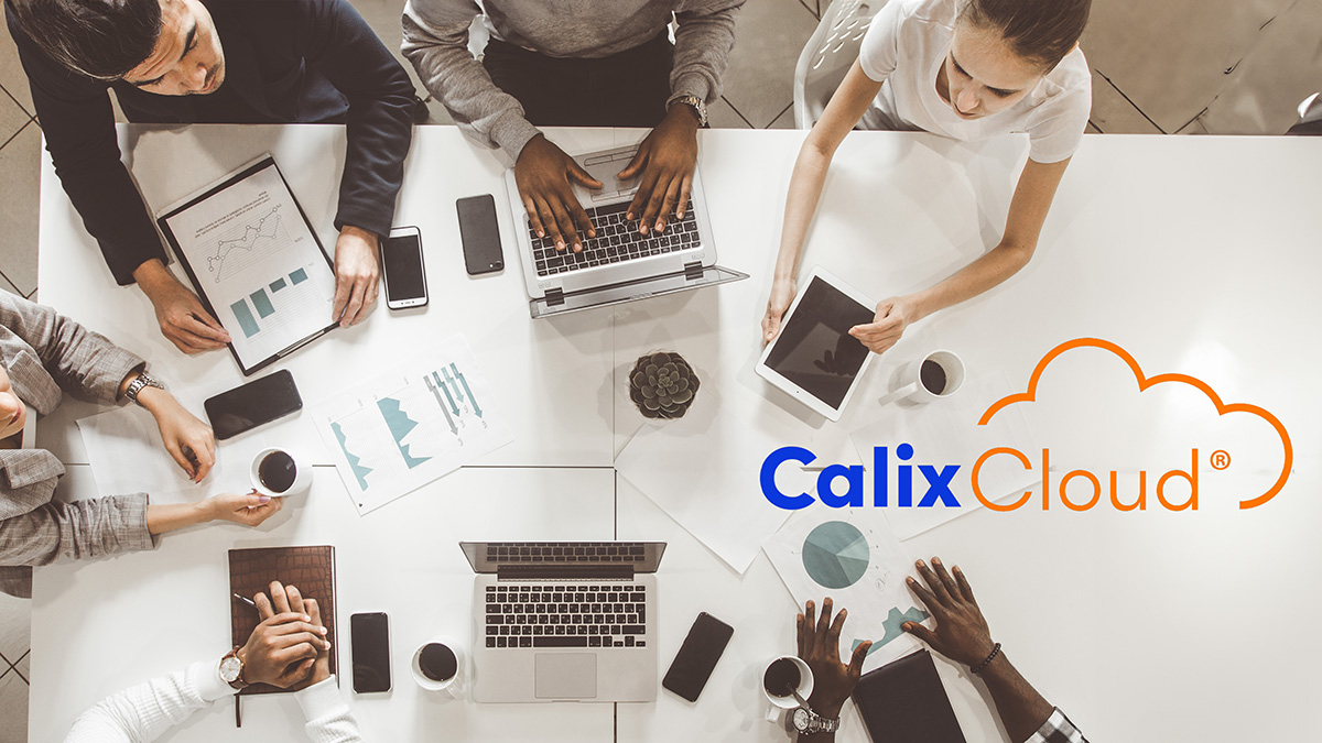 Calix Cloud logo over professionals collaborating with devices at table