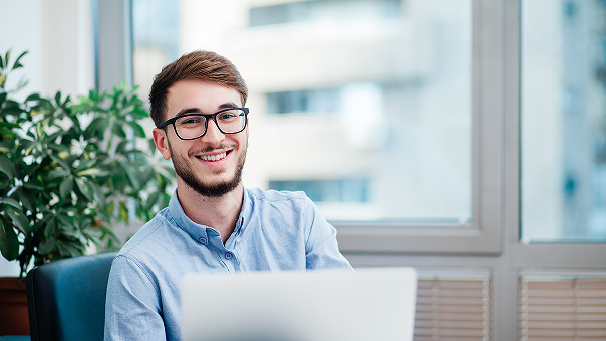 Young businessman in office working on laptop