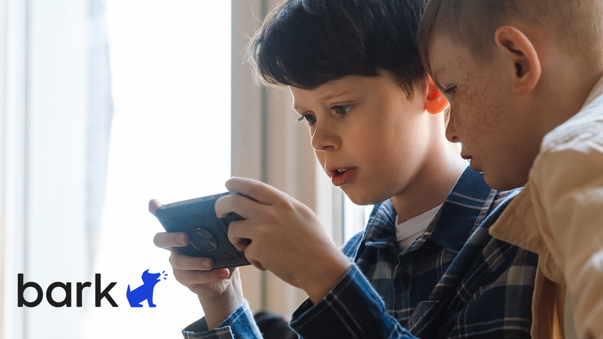 Boy with mobile device and Bark logo