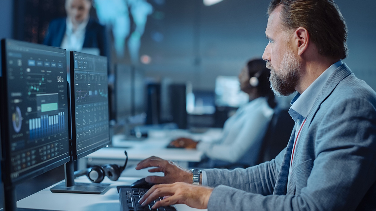 A man working on a computer with analytics information on the screen